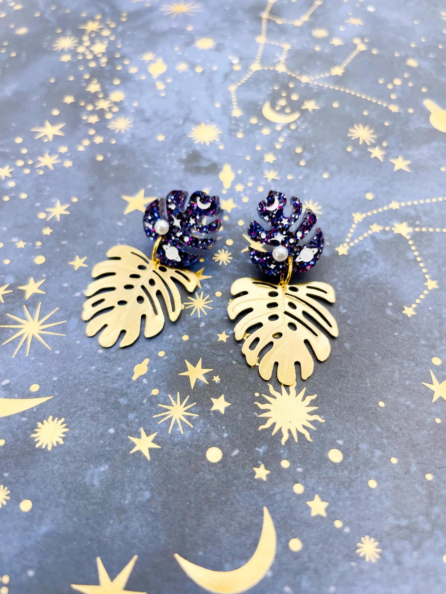 Purple, Blue and Gold Glitter Planet Acrylic Monstera Leaf Duo Dangle Earrings from Sapphire Frills