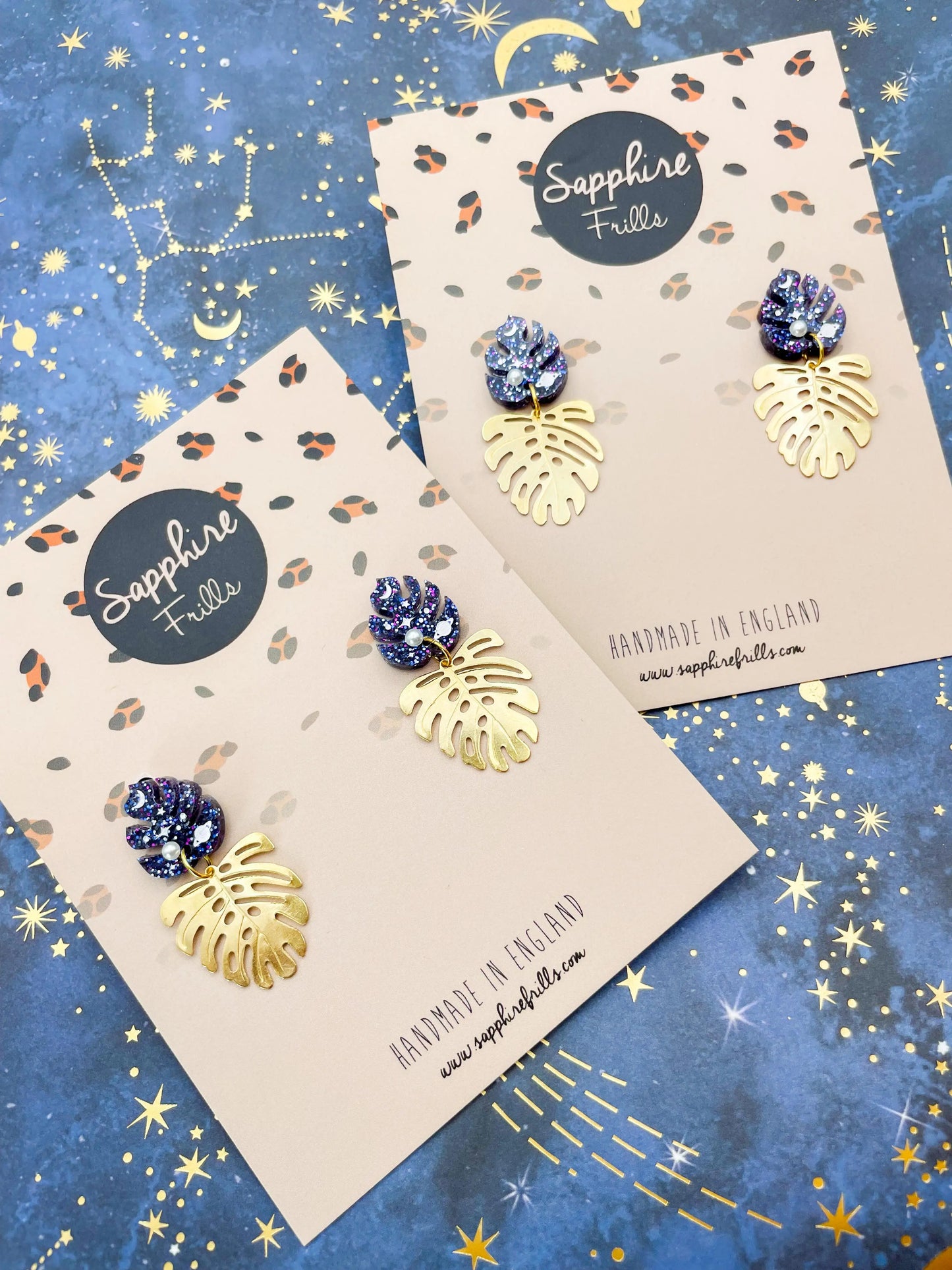 Purple, Blue and Gold Glitter Planet Acrylic Monstera Leaf Duo Dangle Earrings from Sapphire Frills