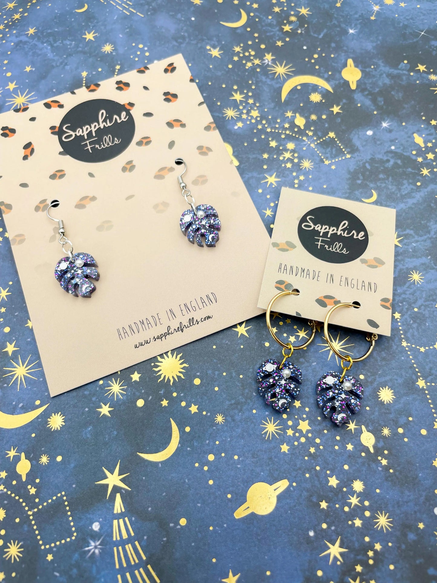 Small Purple and Blue Glitter Planet and Pearl Acrylic Monstera Leaf Hoops from Sapphire Frills