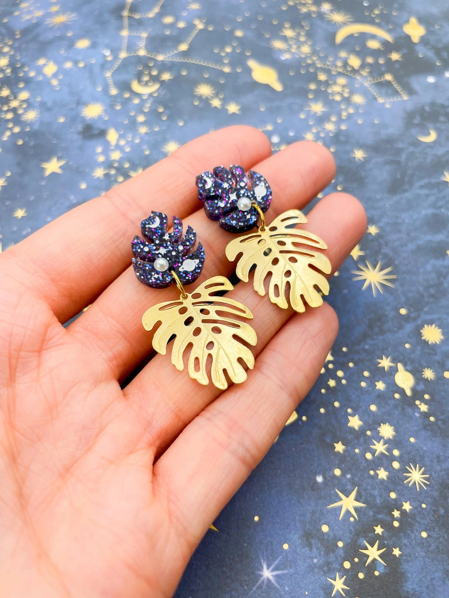 Purple, Blue and Gold Glitter Planet Acrylic Monstera Leaf Duo Dangle Earrings from Sapphire Frills