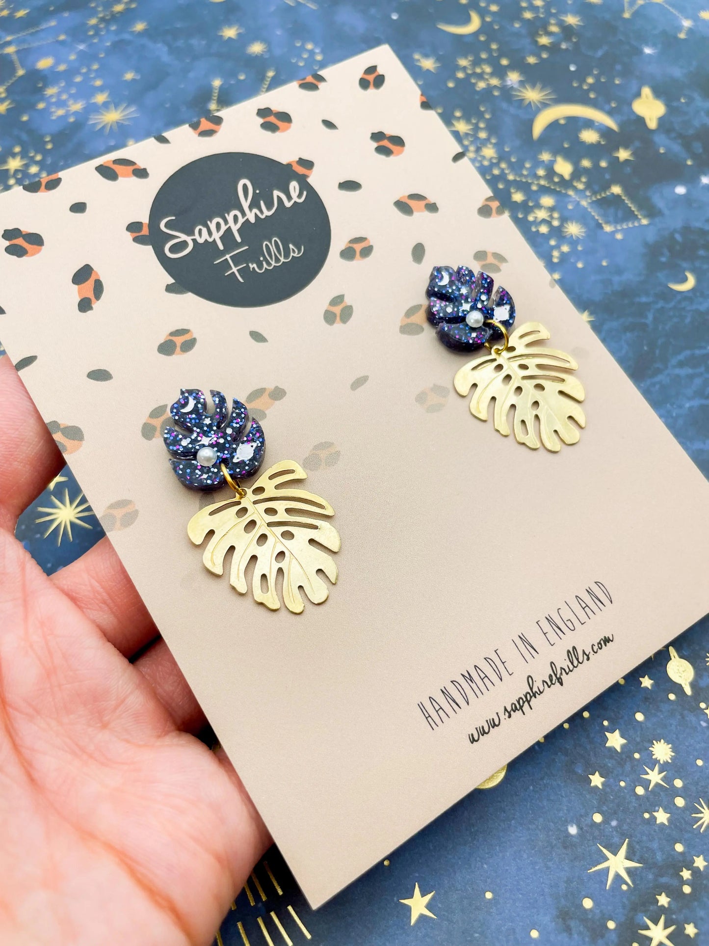 Purple, Blue and Gold Glitter Planet Acrylic Monstera Leaf Duo Dangle Earrings from Sapphire Frills