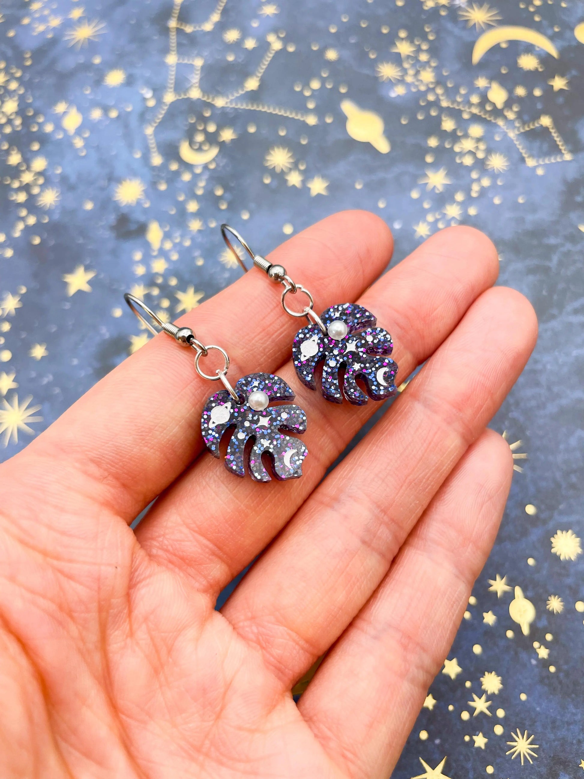 Small Purple and Blue Glitter Planet and Pearl Acrylic Monstera Leaf Hoops from Sapphire Frills